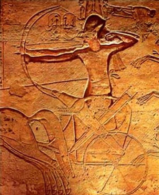 Egyptian horses and chariots: Ramses II fighting in a chariot at the Battle of Kadesh with two archers, one with the reins tied around his waist to free both hands. Relief from Abu Simbel. 