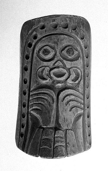 Shaman's totem charm of bone carved in British Columbia, Canada. Designs representing the octopus and bird. Abalone inlays in eyes. Hole pierced at top for pendant. 
